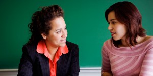Teacher teaching student in classroom
