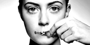 Woman zippering mouth closed