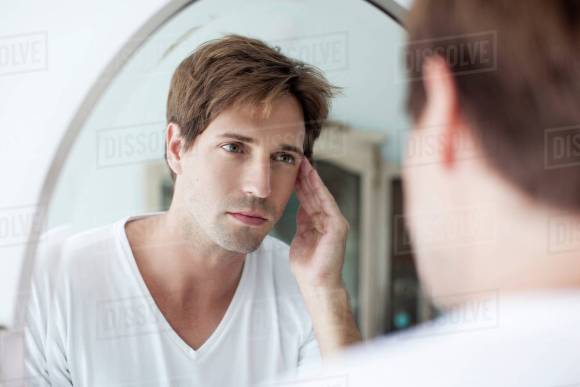 man looking in a mirror